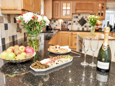 A kitchen with food and drinks on the counter at Oldfields