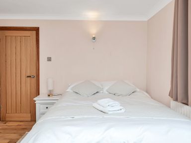 A bedroom with a bed and nightstand at Oldfields