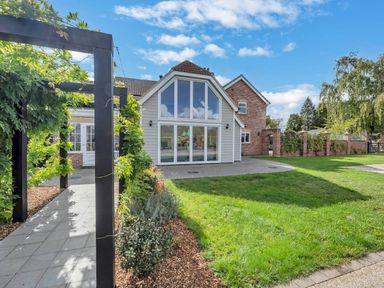 An exterior view of a house with a pathway and garden at Oldfields in Bury St Edmunds