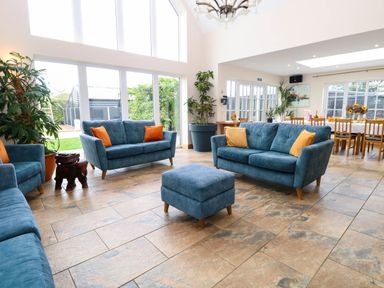 A living room with sofas and an ottoman at Oldfields in Bury St Edmunds