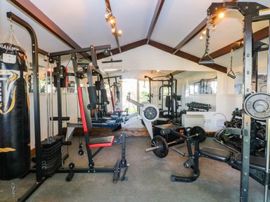 A gym with various exercise equipment at Oldfields in Bury St Edmunds