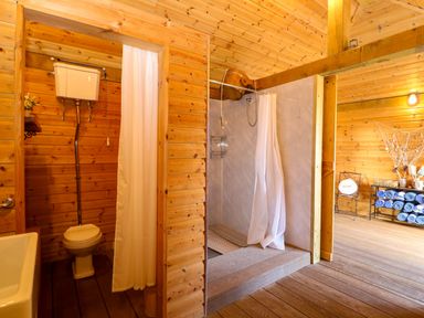 A bathroom with sink, shower, and towels at Oldfields in Bury St Edmunds
