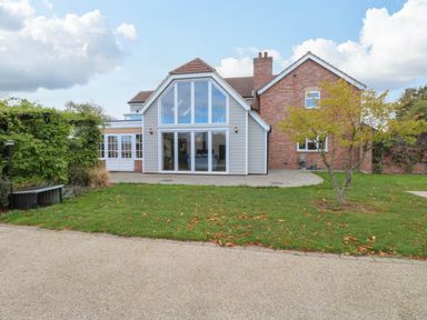 A house with large windows and a garden at Oldfields in Bury St Edmunds