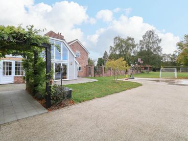 An outdoor area with a house and sports equipment at Oldfields in Bury St Edmunds