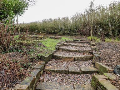 Stone steps leading up through a garden area at The Lodge House in Dolphinholme near Galgate