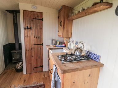 A kitchen with a stove and kettle at Honeysuckle Hut, Potto Grange Farm, Northallerton