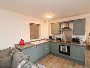 A kitchen with cabinets and appliances at Tooth Suite in Yarm