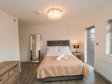 A bedroom with a bed and nightstand at Tooth Suite in Yarm