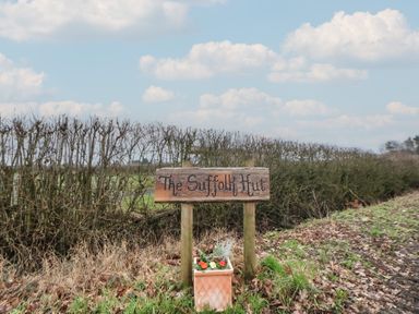 A sign for The Suffolk Hut with flowers at The Suffolk Hut in Knutsford