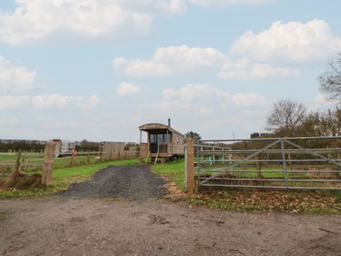 A building with a gate and gravel path at The Suffolk in Knutsford