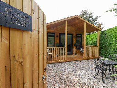 An outdoor area with a lodge and seating at St. Chad's Lodge in Bodmin