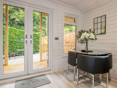 A dining room with a table and chairs at St. Chad's Lodge in Bodmin
