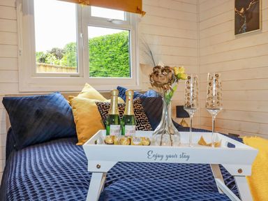 A bedroom with a tray of champagne and glasses at St. Chad's Lodge in Bodmin