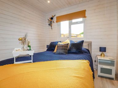 A bedroom with a bed and decorative items at St. Chad's Lodge in Bodmin