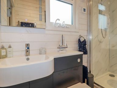 A bathroom with a sink and shower at St. Chad's Lodge Bodmin