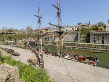 A view of boats and masts on a waterway at St. Chad's Lodge in Luxulyan