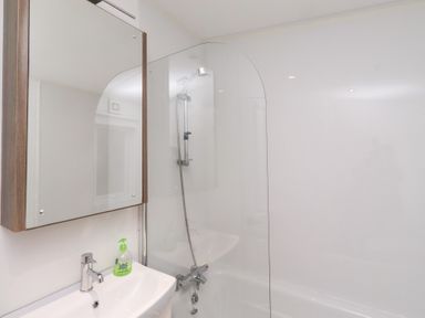 A bathroom with a sink and shower at Chloe's Cabin near Felmoor Holiday Park