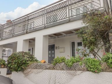 A house with a balcony and plants at Rock House in Narberth
