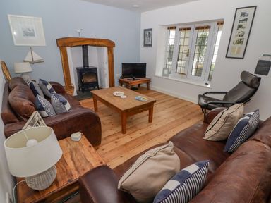 A living room with a sofa and table at Rock House Narberth