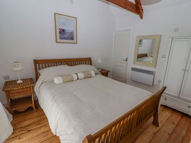 A bedroom with a bed and nightstand at Rock House Narberth