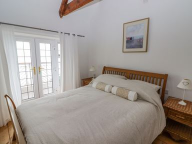 A bedroom with a bed and bedside tables at Rock House in Narberth