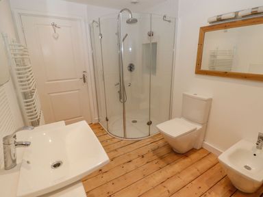 A bathroom with shower, toilet, sink, and bidet at Rock House in Narberth