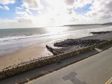 A beach with sand and waves at Rock House in Narberth
