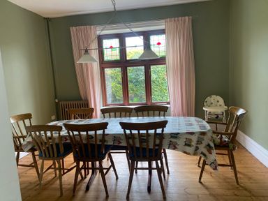 A dining room with a table and chairs at Kenvor, Newport, Pembrokeshire
