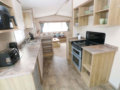 A kitchen with a stove and sink in 82 Manorbier Park, Manorbier