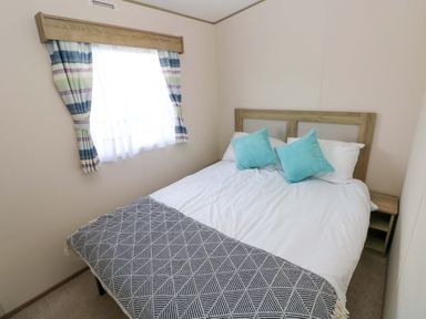 A bedroom with a bed and window at 82 Manorbier Park in Manorbier