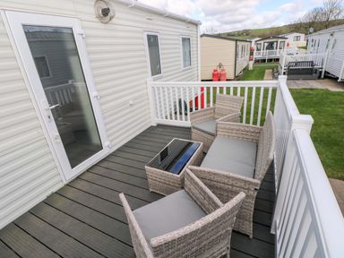 An outdoor seating area with chairs and a table at 82 Manorbier Park in Manorbier