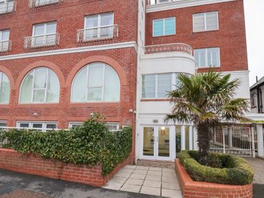 A building with windows and an entrance at One Union Mill - garden apartment in Whitby