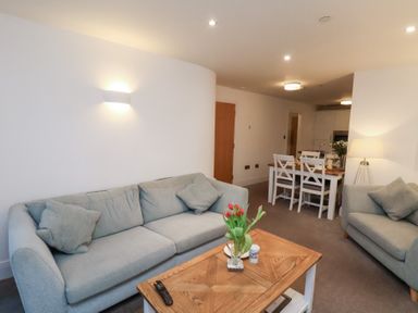 A living room with a sofa and coffee table at One Union Mill - garden apartment Whitby