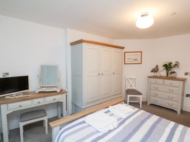 A bedroom with a bed and furniture at One Union Mill - garden apartment in Whitby