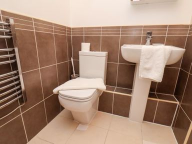 A bathroom with a toilet and sink at One Union Mill - garden apartment in Whitby