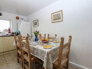 A dining room with a table and chairs at Parc y Brenin Holidays, Abersoch