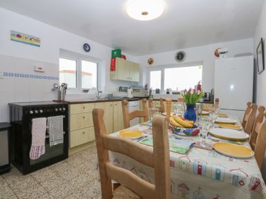 A kitchen with a dining table and chairs at Parc y Brenin Holidays, Abersoch
