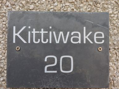 A nameplate with Kittiwake 20 on it at Kittiwake at No 20 Seahouses