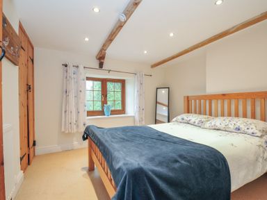 A bedroom with a bed and window at Little Blagdon in Beaworthy