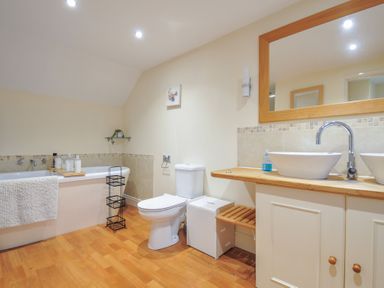 A bathroom with a bathtub and sink at Little Blagdon Beaworthy