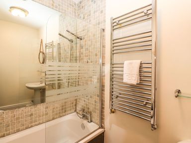 A bathroom with a bathtub and shower at Waterhead Cottage in Ambleside