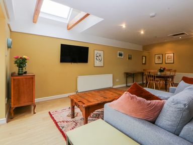 A living room with a sofa and coffee table at Inglewood Bach Conwy