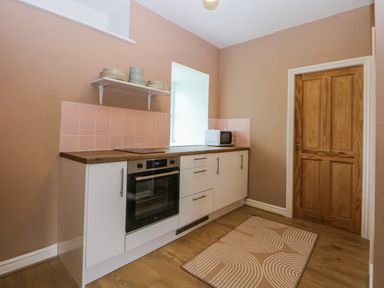 A kitchen with a countertop and appliances at Inglewood Bach in Conwy