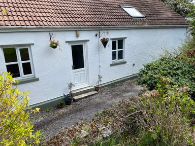 An exterior view of a house with a door and windows at Inglewood Bach, Conwy