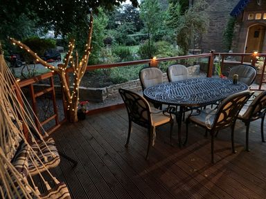 An outdoor porch with a table and chairs at The Hermitage in Penrith