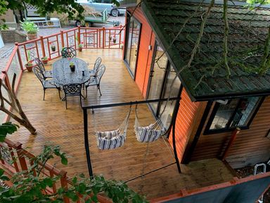 A deck with a table and chairs at The Hermitage in Penrith