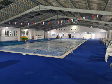 An indoor pool area with covered pool and seating at Chalet 58, California, Norfolk