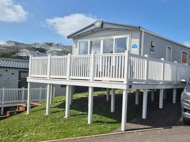 A mobile home with a deck and steps at 21 Gorse Hill in Exmouth
