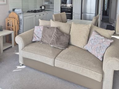 A living room with a sofa and kitchen in view at 21 Gorse Hill, Exmouth
