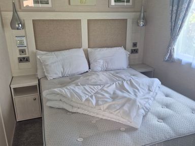 A bedroom with a bed and bedside table at 21 Gorse Hill in Exmouth